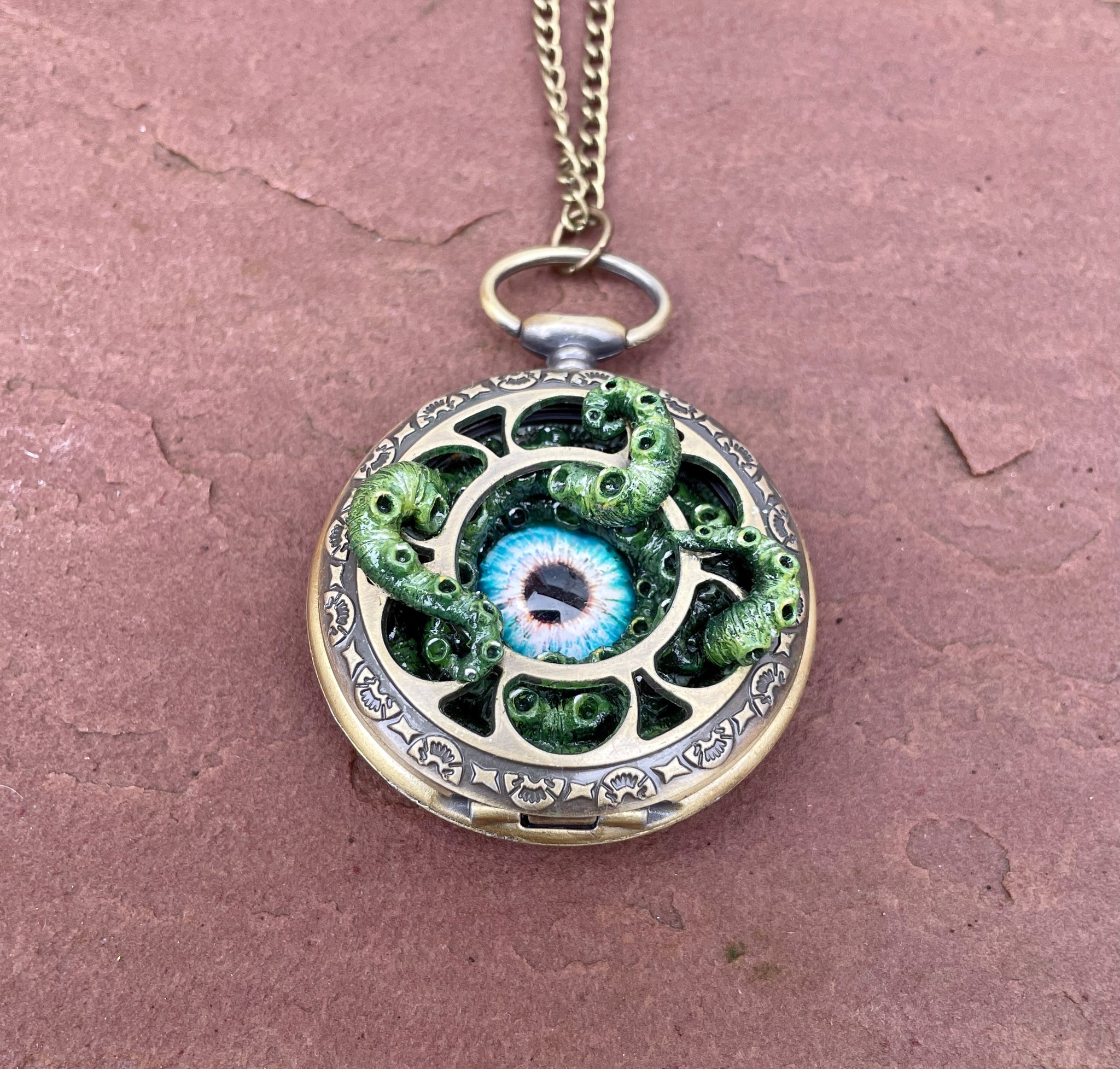 Piercing Blue Eyed Pocket Kraken Little Dragon Designs